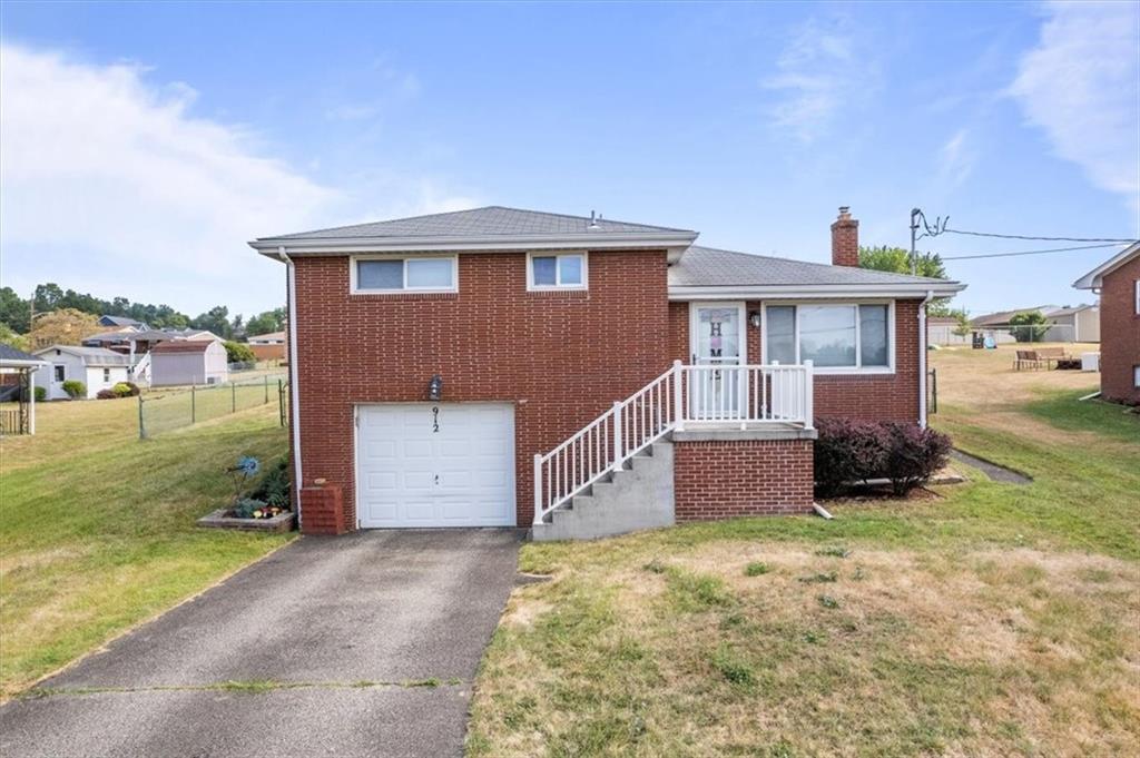 a view of a house with a yard and garage