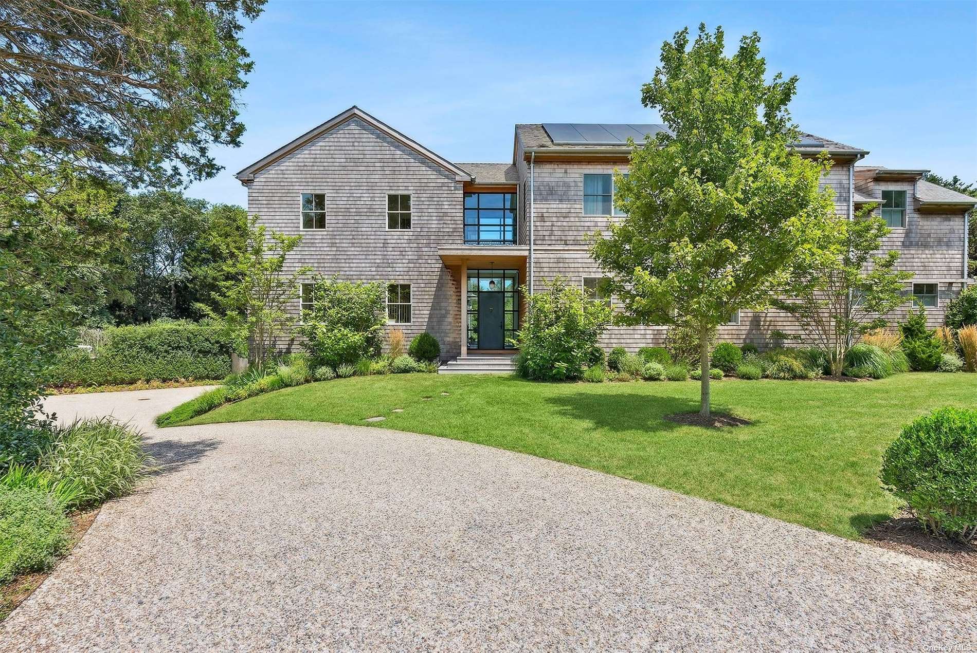 a front view of house with yard and green space