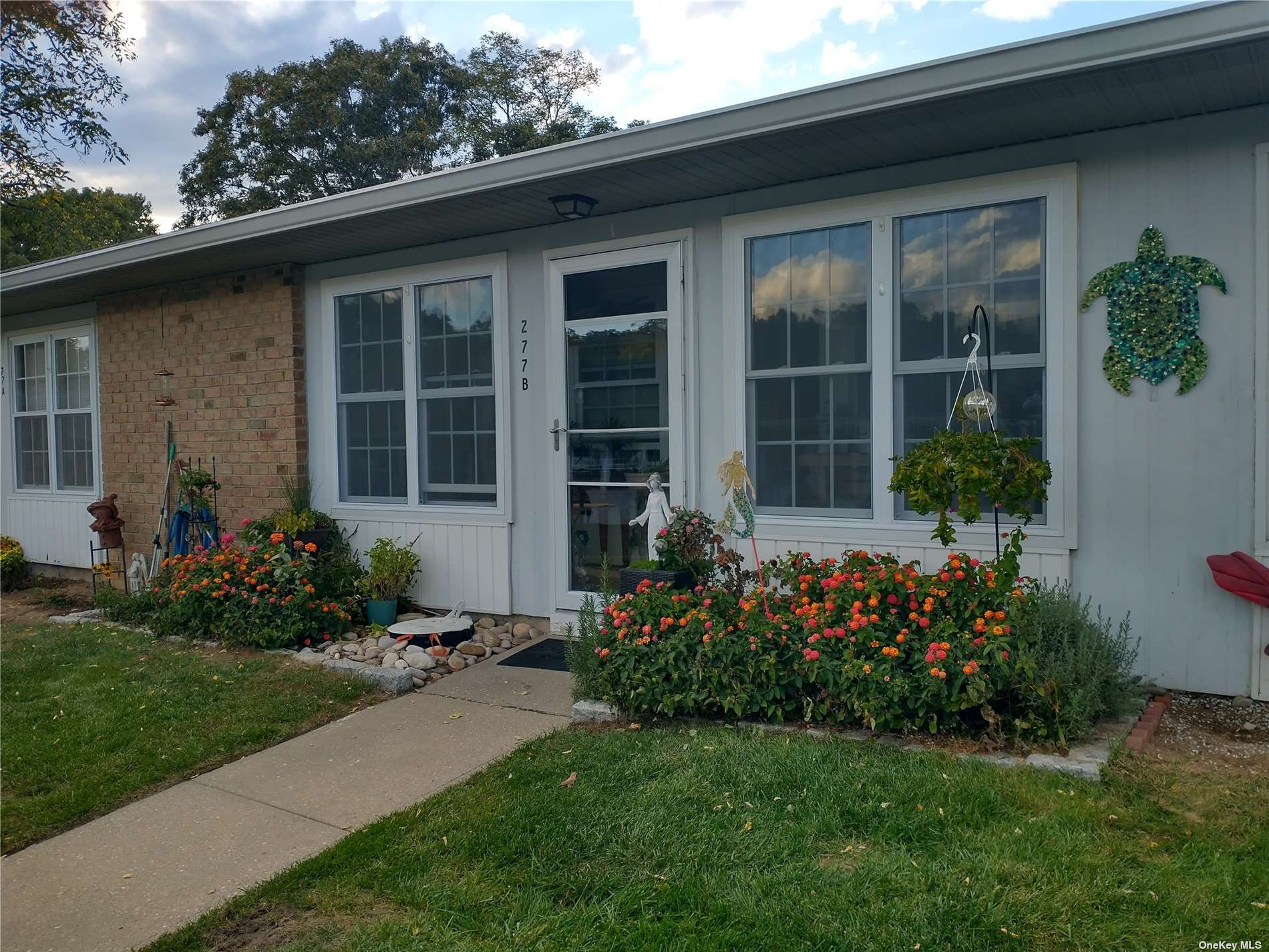 a front view of a house with garden