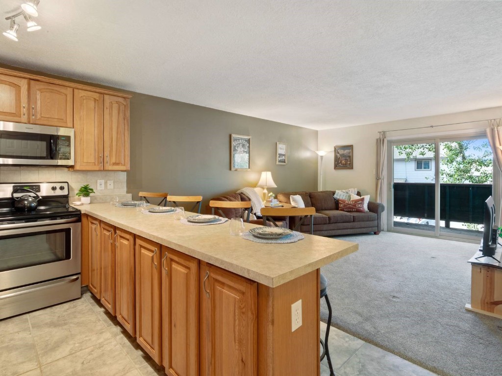 a kitchen with sink stove and cabinets