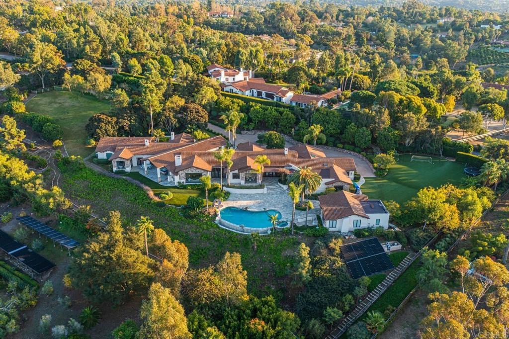 an aerial view of residential houses with outdoor space and swimming pool