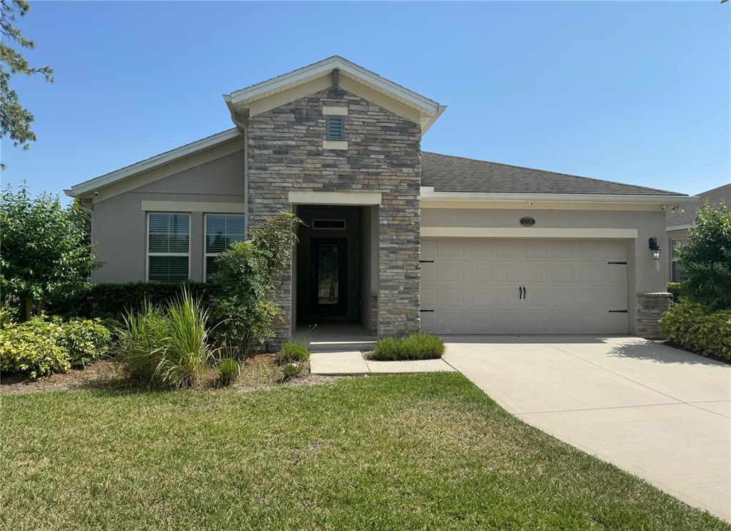 a front view of a house with a yard and garage