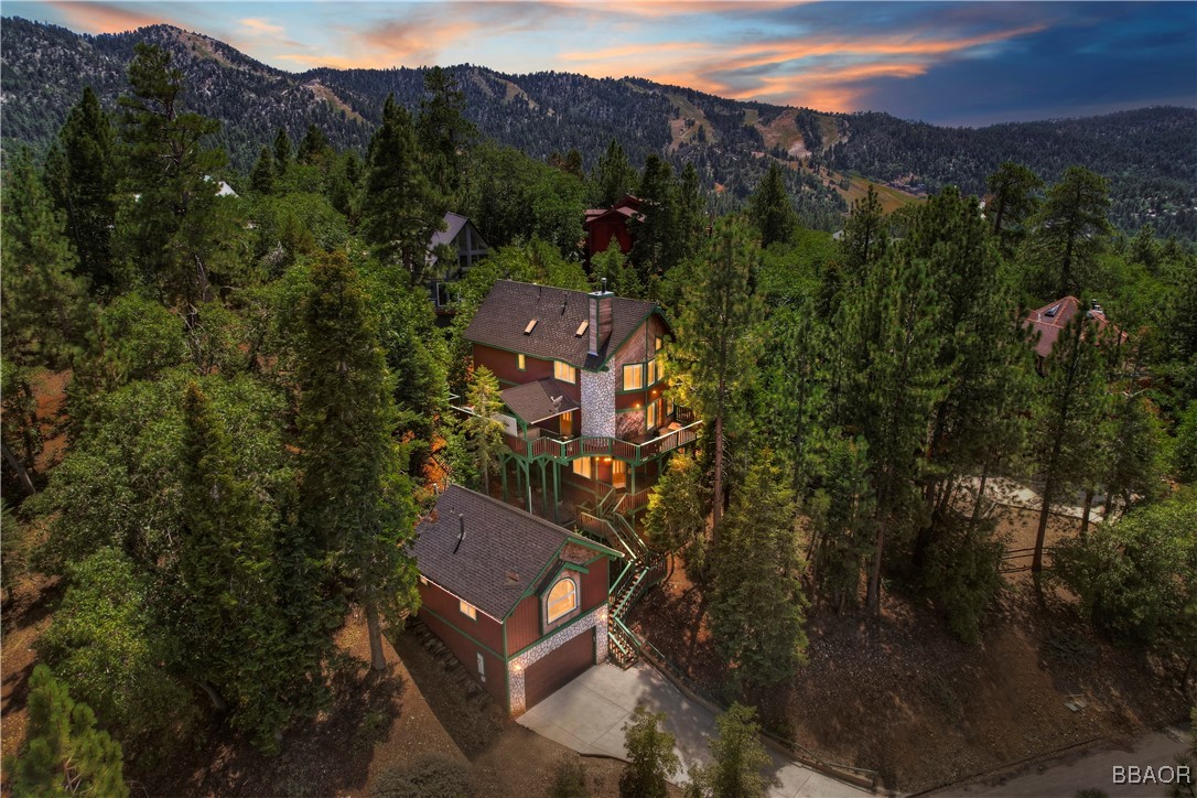 an aerial view of a house with mountain view