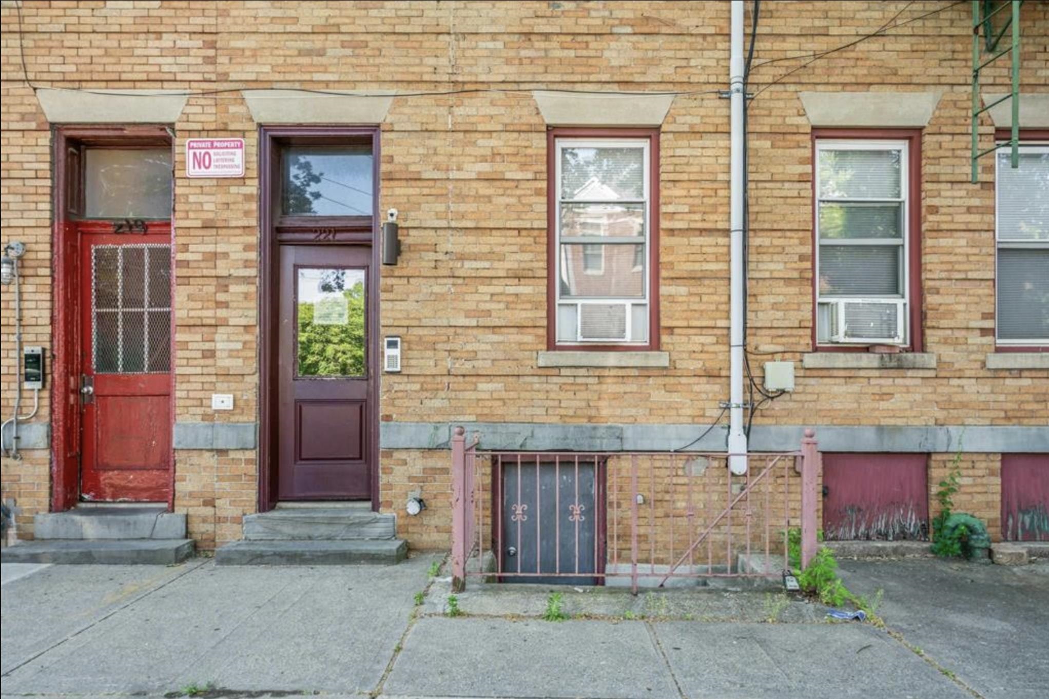 a brick building with a bench and windows