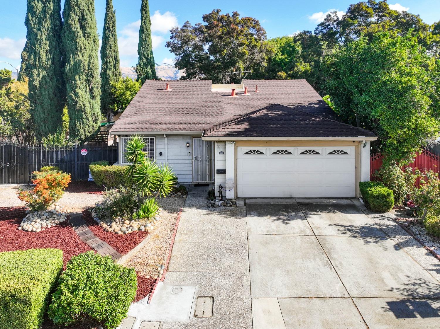 a front view of a house with a yard and a garage