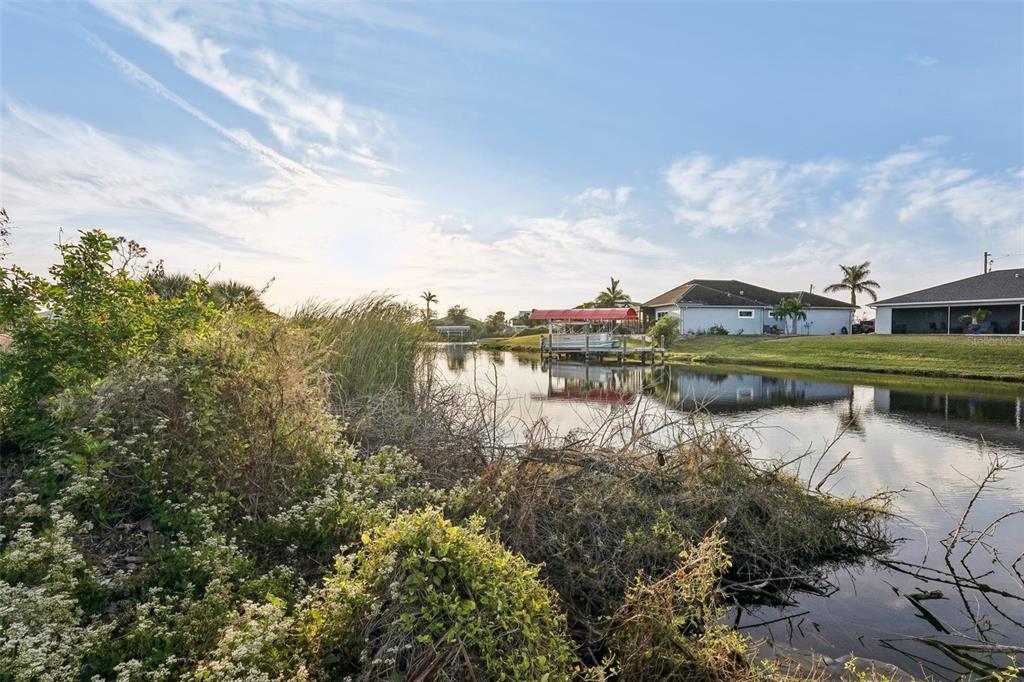 a view of a lake with houses in the back