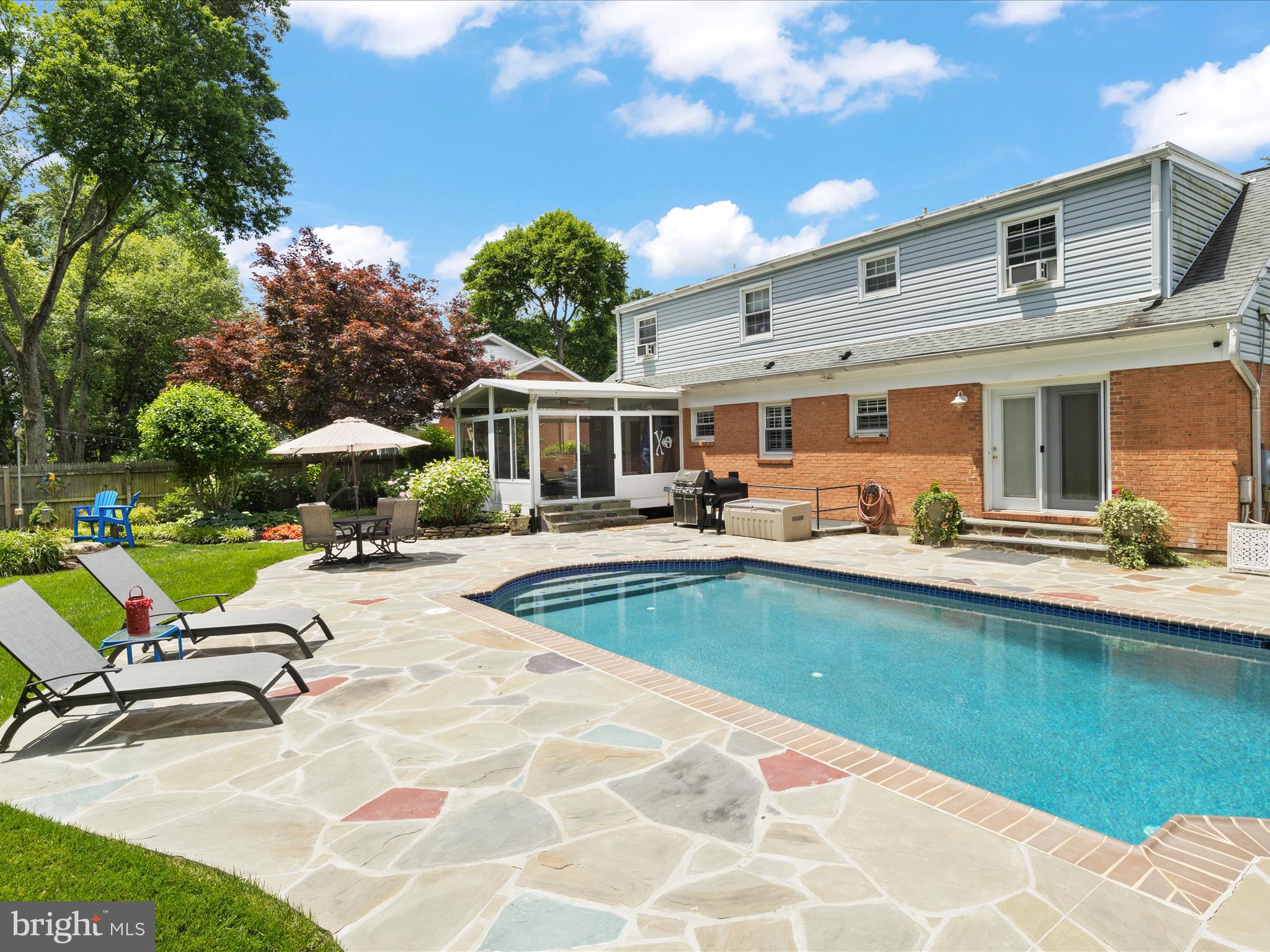 a view of a house with swimming pool and sitting area