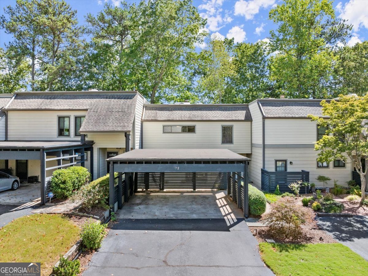 a view of a house with a patio and a yard