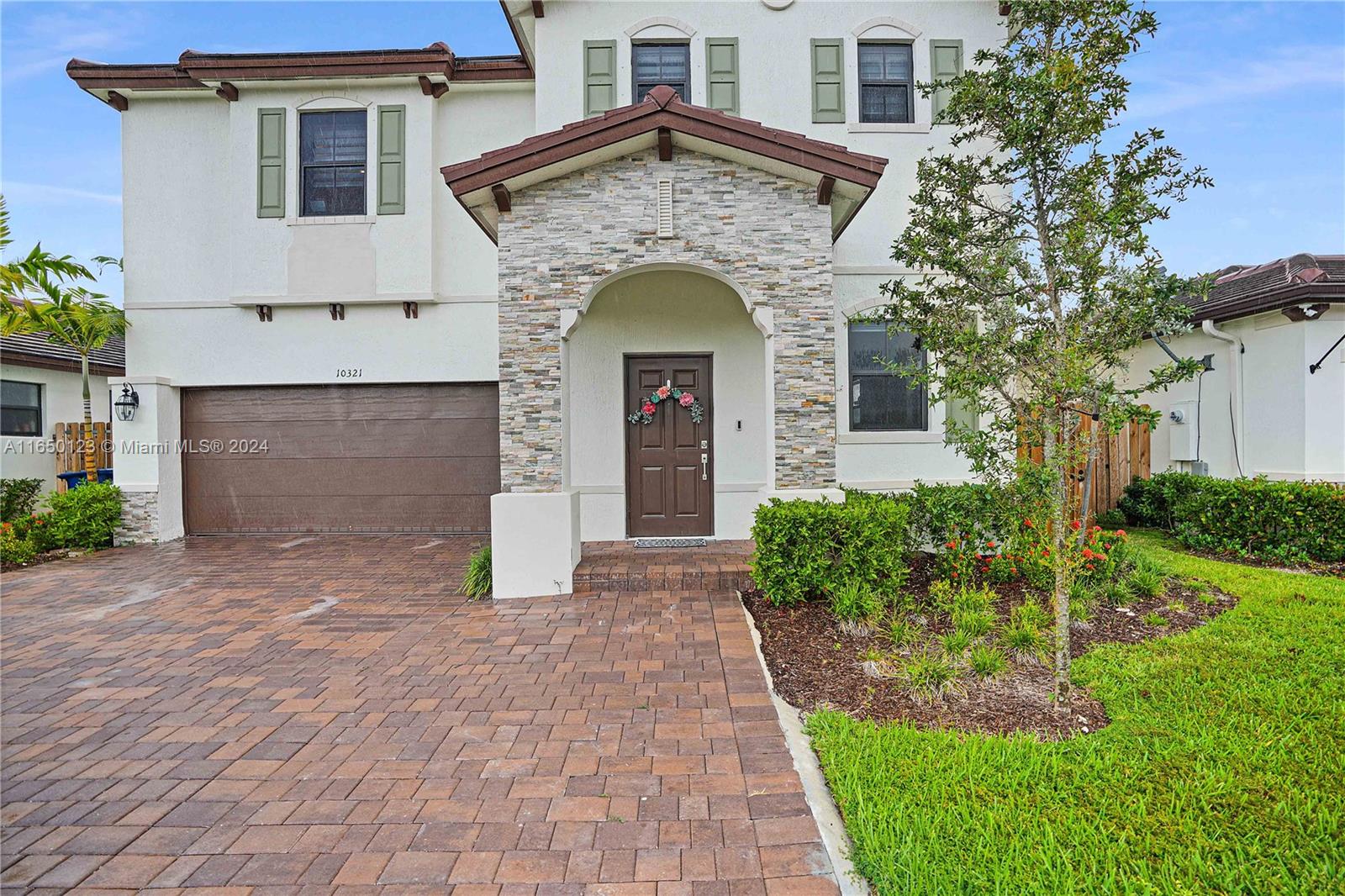 a front view of a house with garden