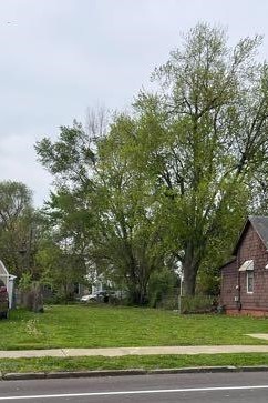 a view of a yard with a house in the background