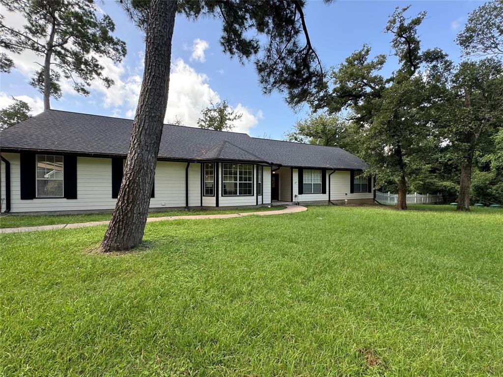 a house with green field in front of it