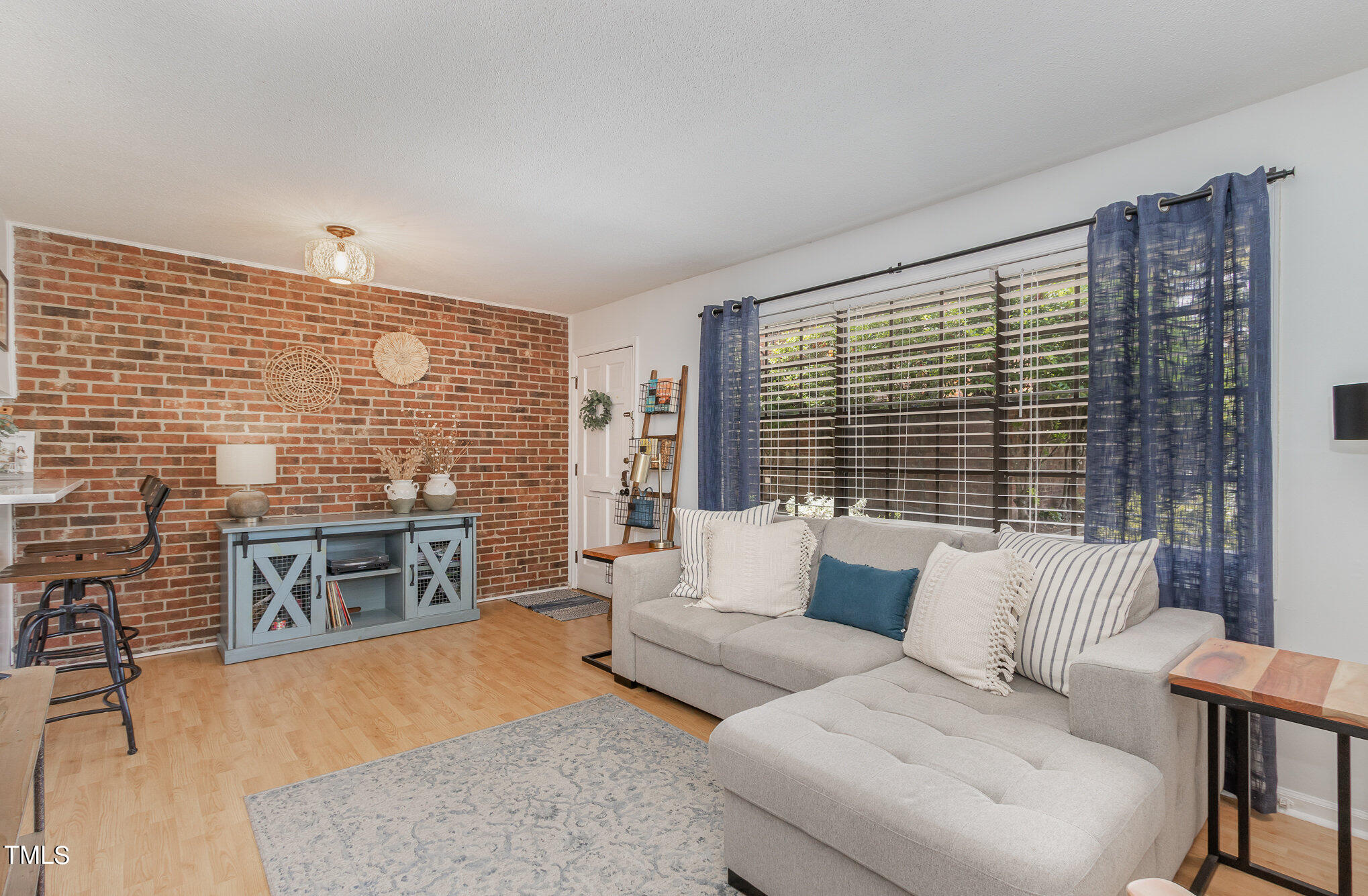 a living room with furniture windows and wooden floor