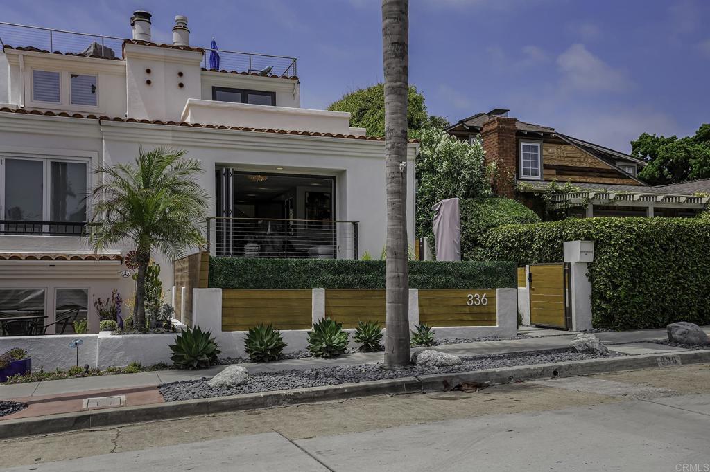 a front view of a house with a garden and plants