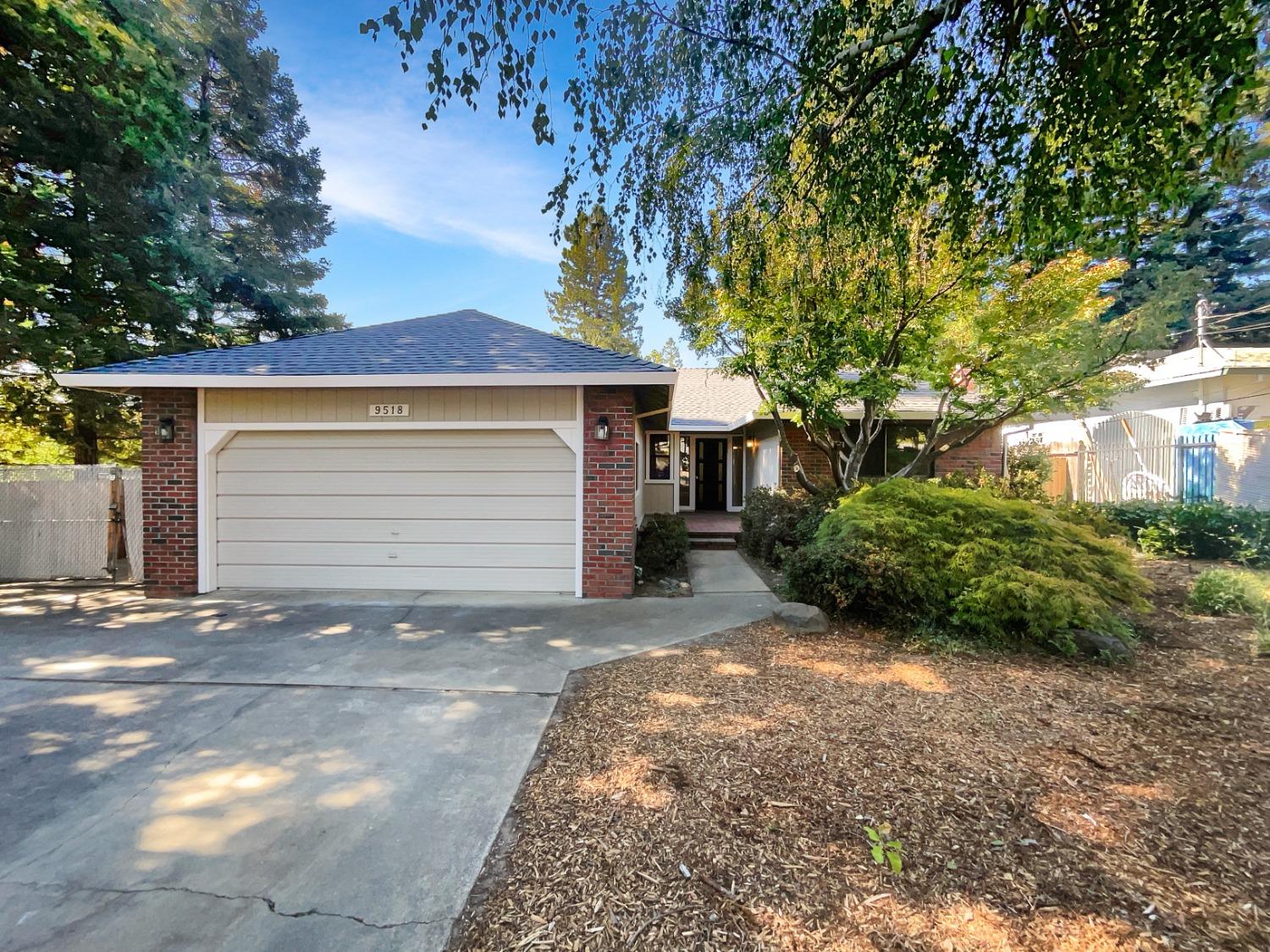 a view of a house with a yard and garage