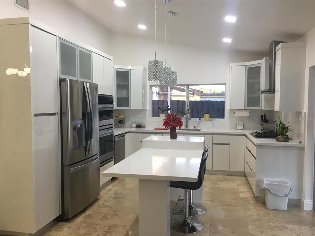 a kitchen with a refrigerator a sink and a refrigerator