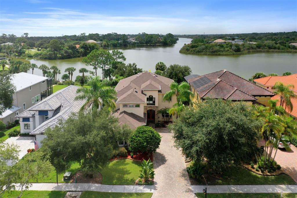 an aerial view of a house with outdoor space and lake view