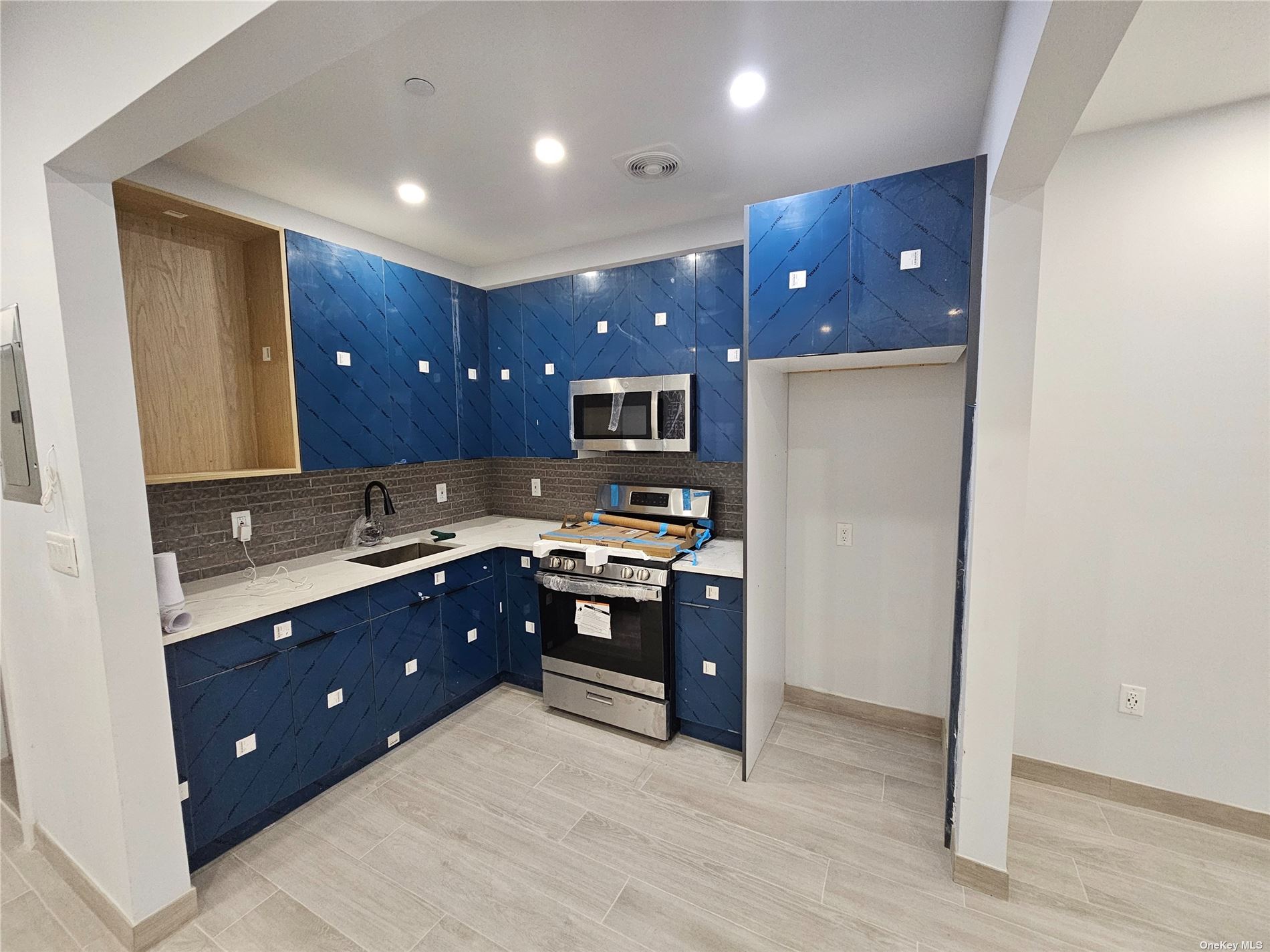 a kitchen with stainless steel appliances granite countertop wooden cabinets a sink and dishwasher