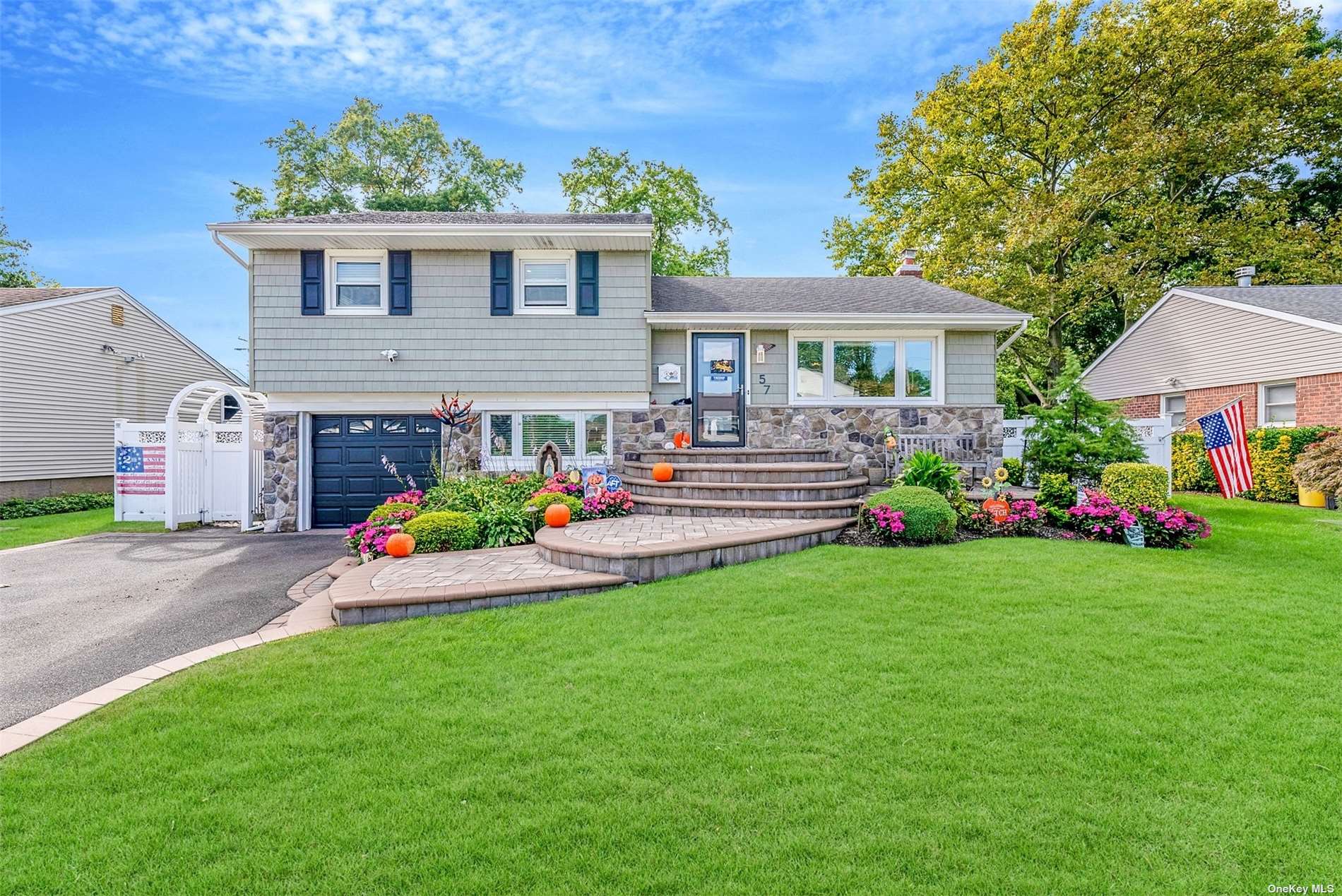 a front view of house with yard and green space