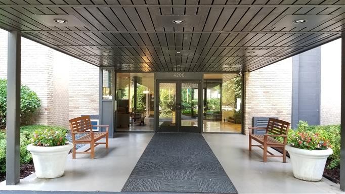 a building outdoor space with patio furniture and potted plants