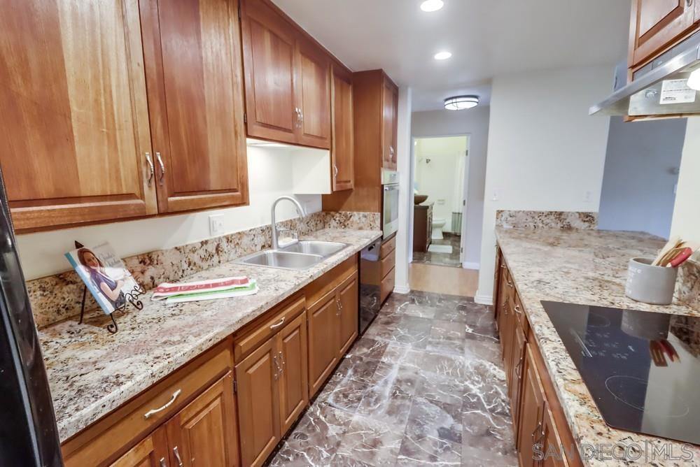 a spacious bathroom with a granite countertop sink and a mirror