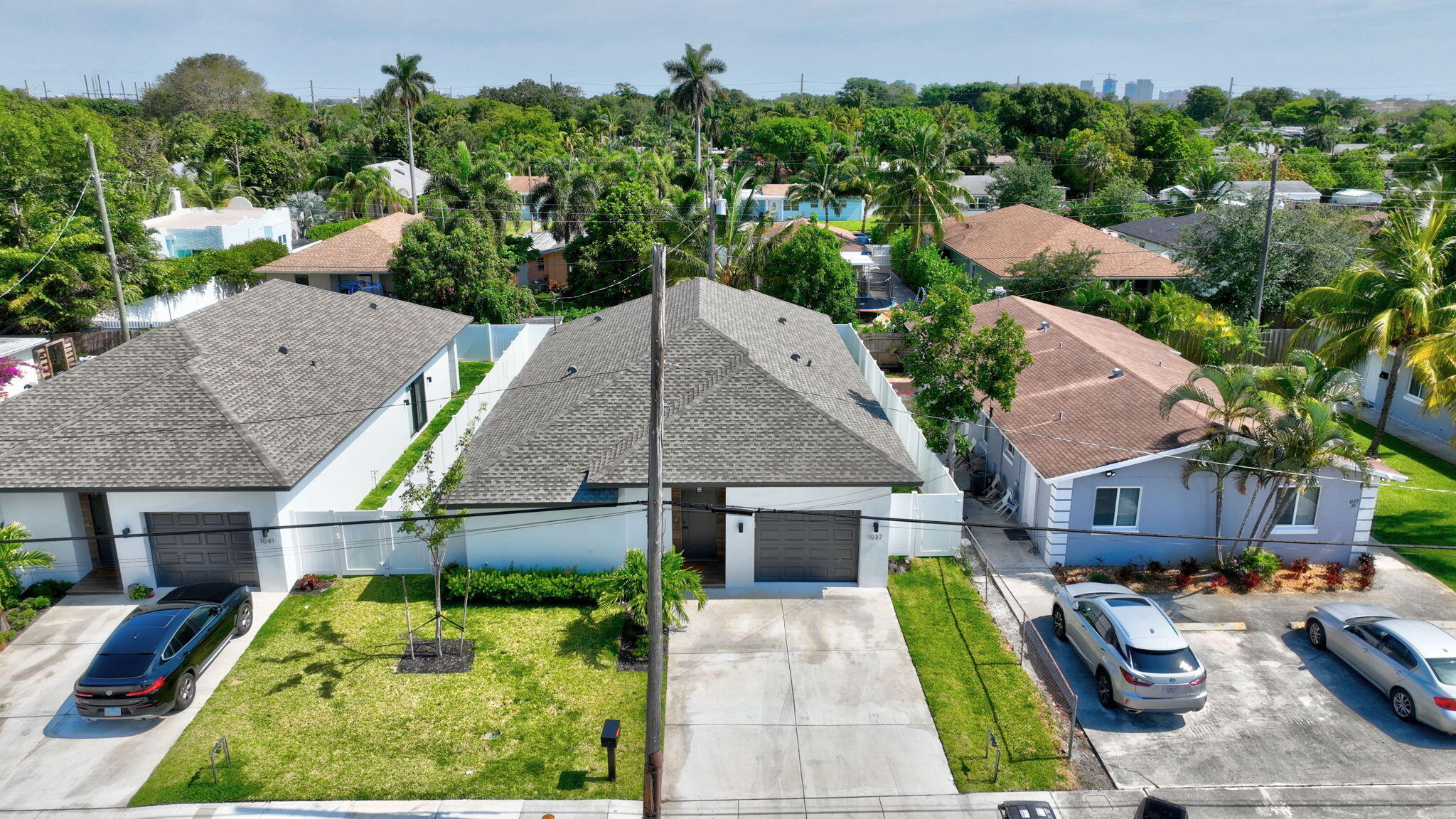 an aerial view of a house with swimming pool and large trees