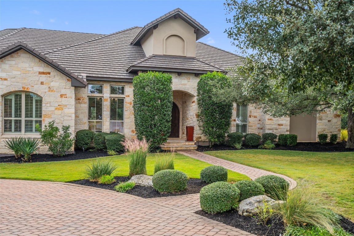 a front view of a house with garden