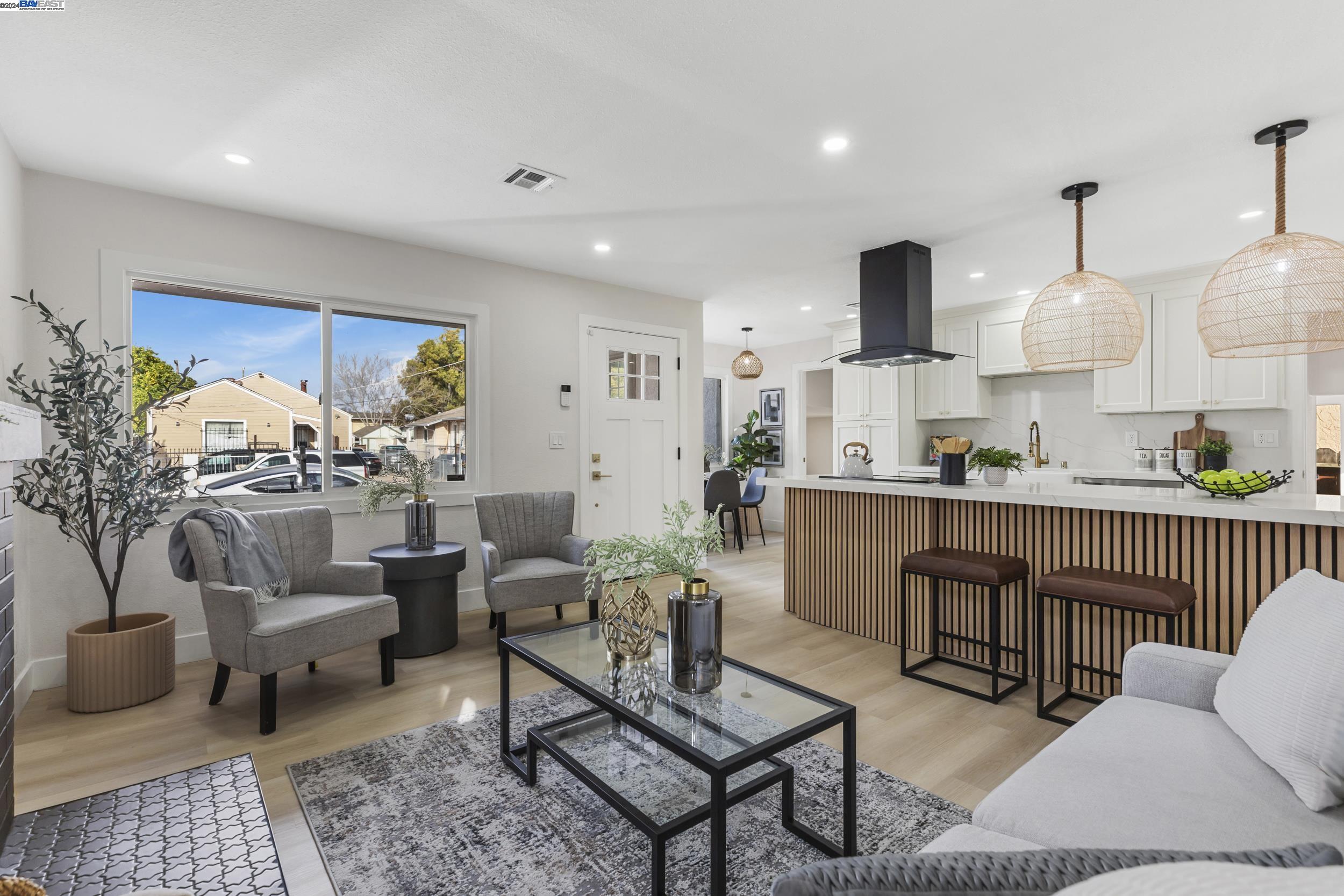 a living room with furniture kitchen view and a rug