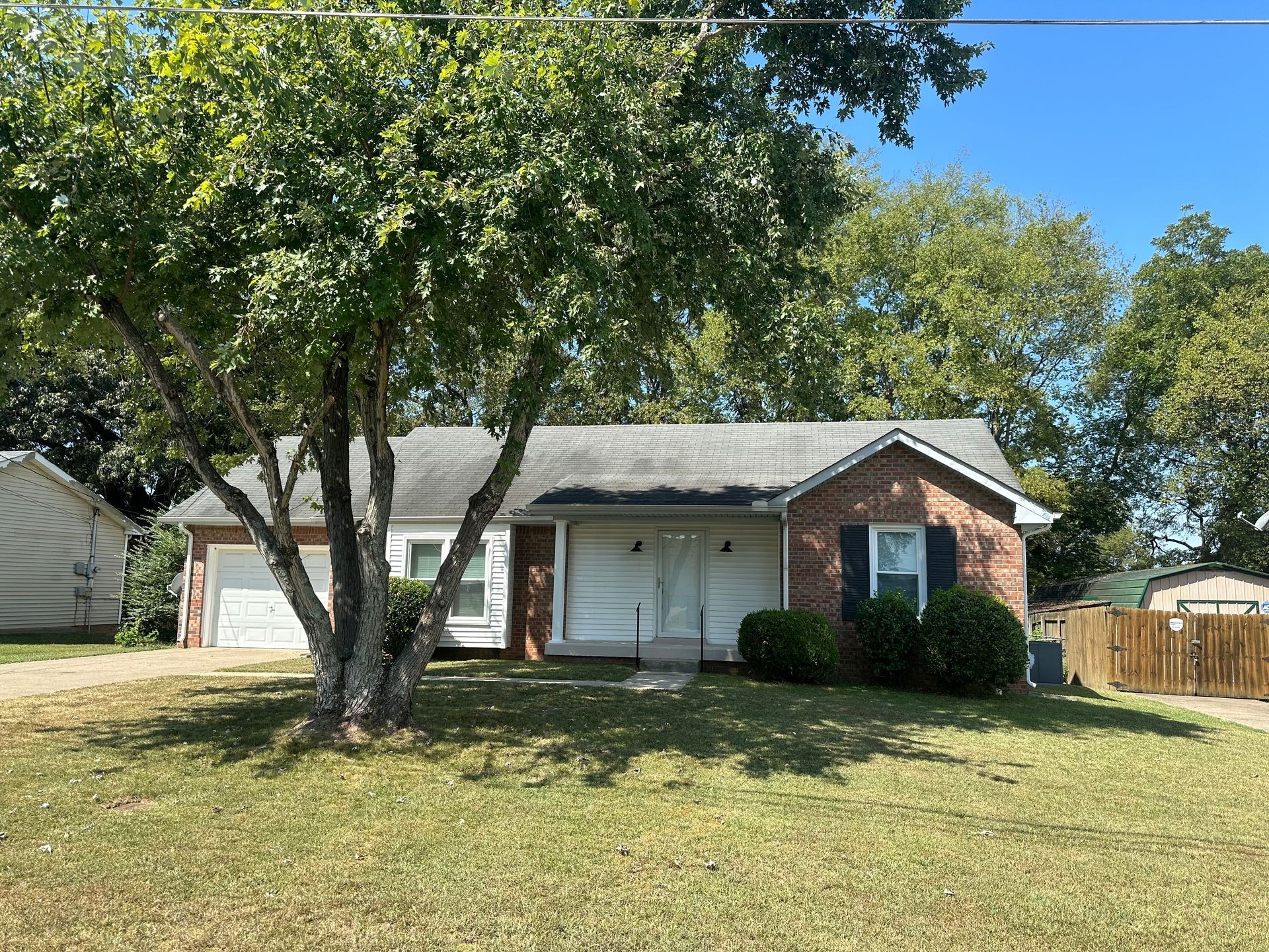 a view of a house with a tree in the yard