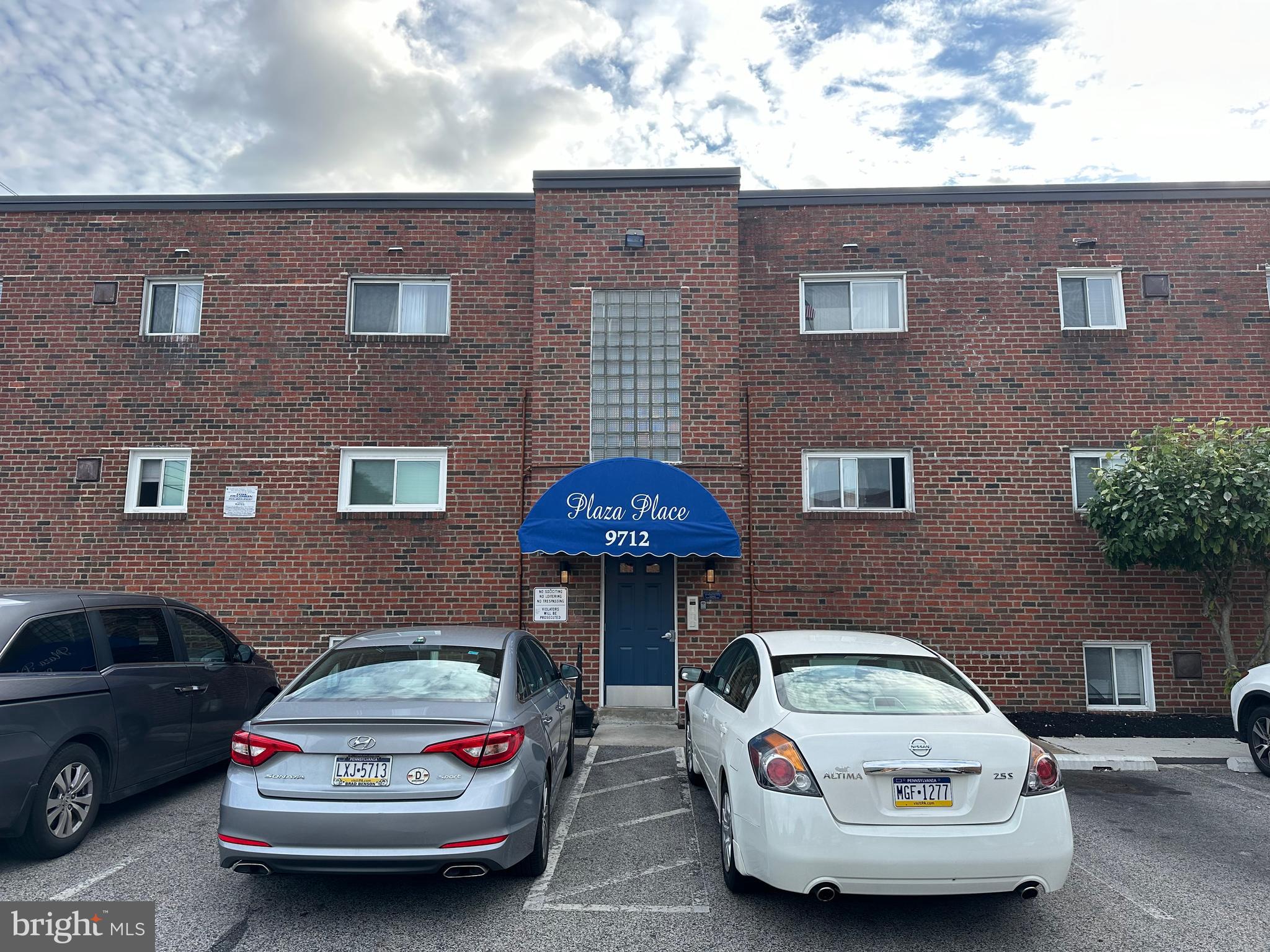 a car parked in front of a brick building