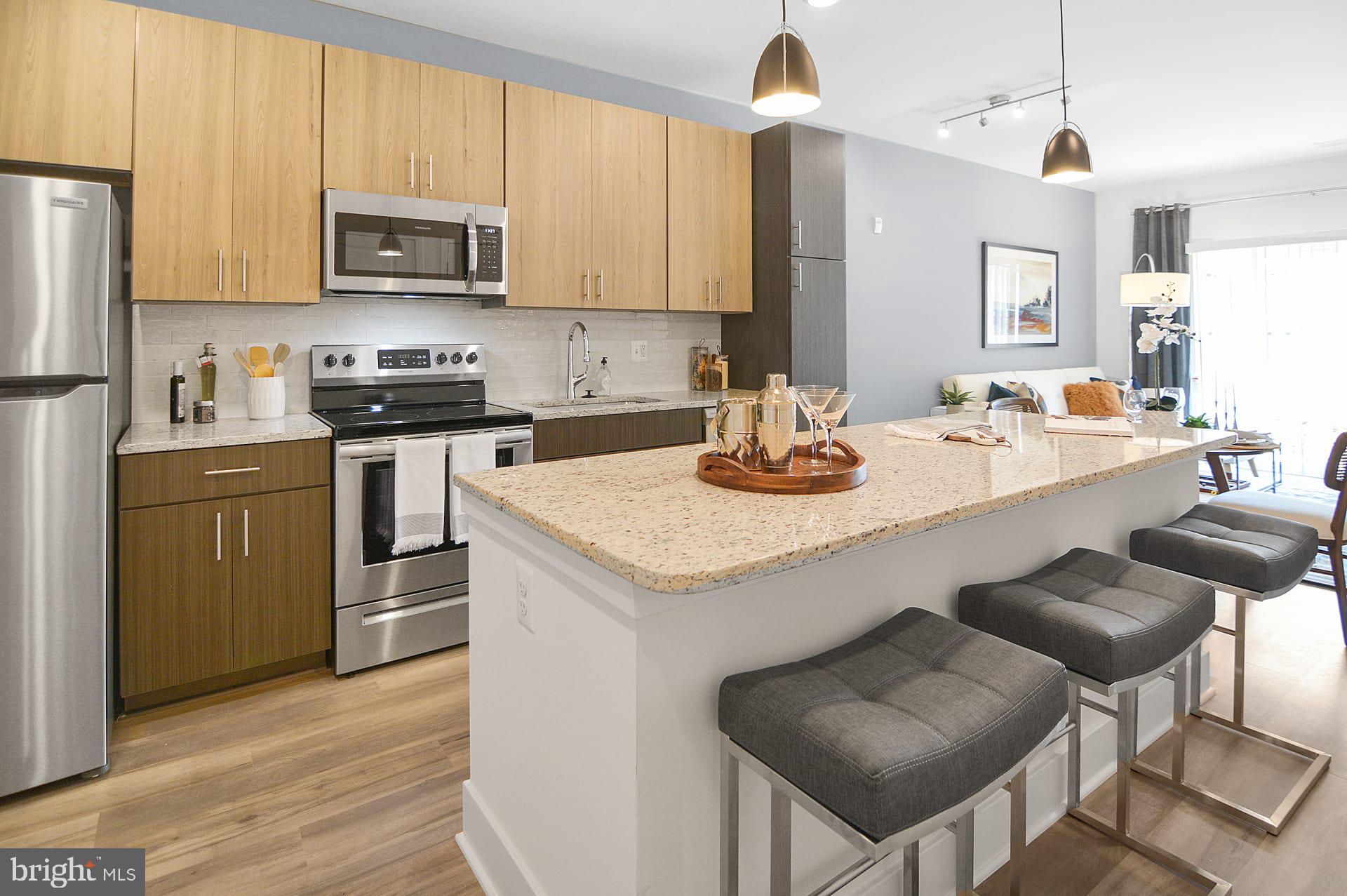 a kitchen with sink a microwave and cabinets