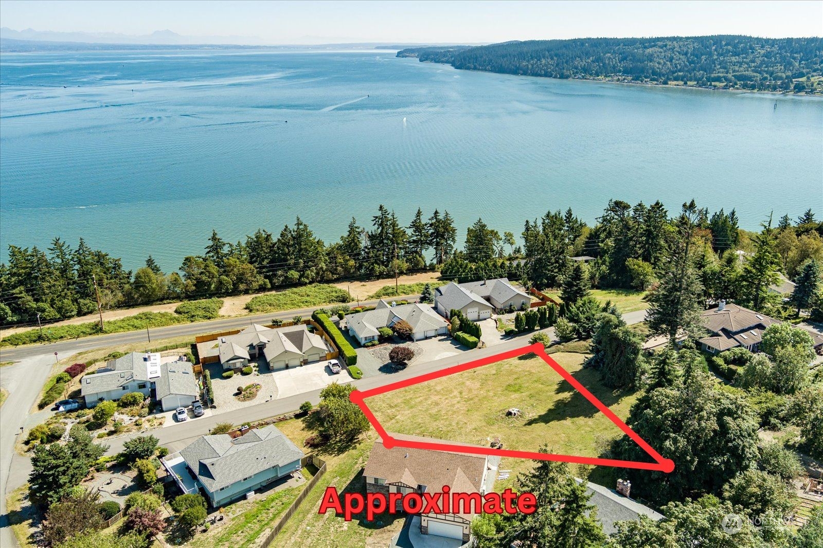 an aerial view of a house swimming pool and lake view