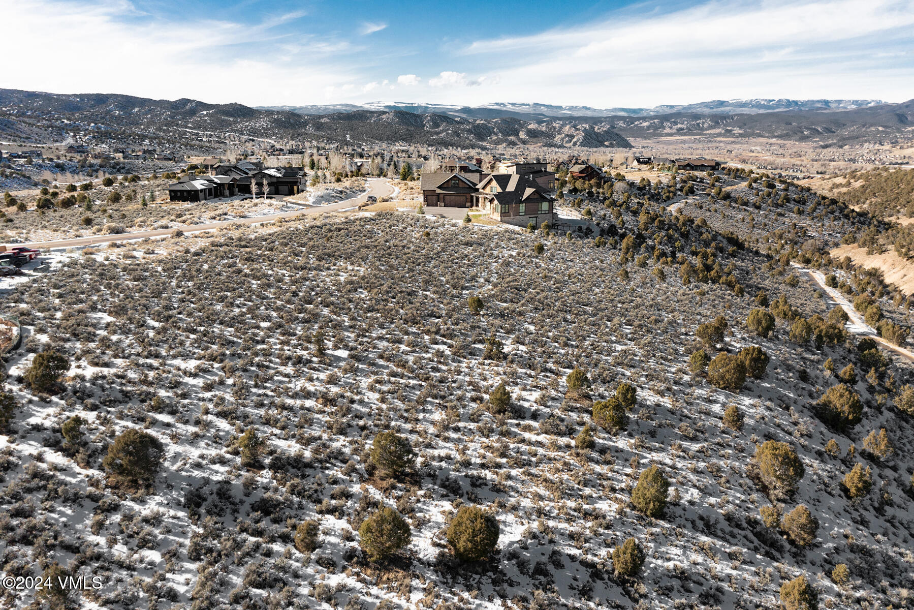 an aerial view of residential houses with city view