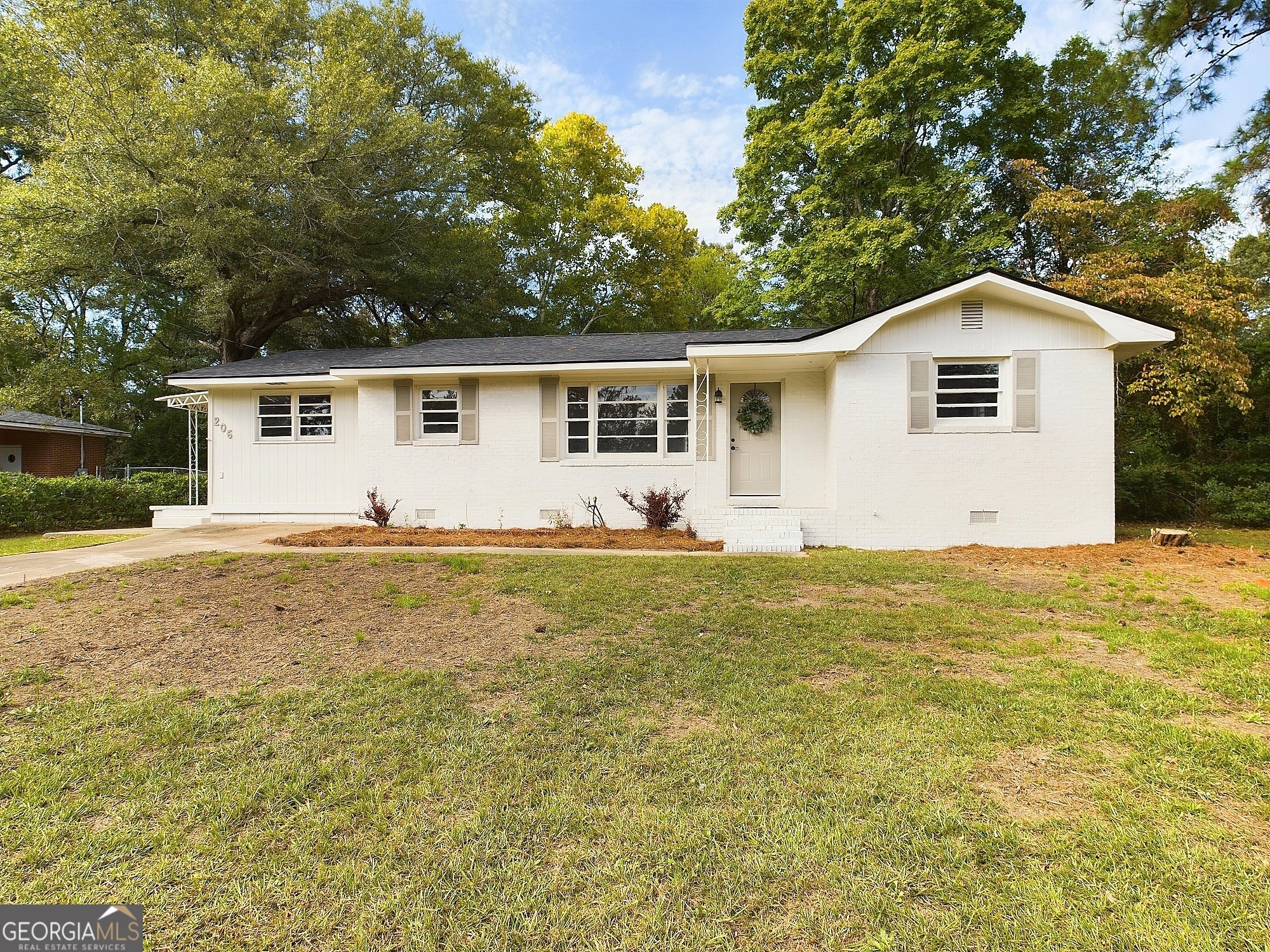 a front view of house with yard and trees