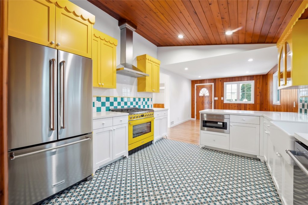 a kitchen with a refrigerator and a stove