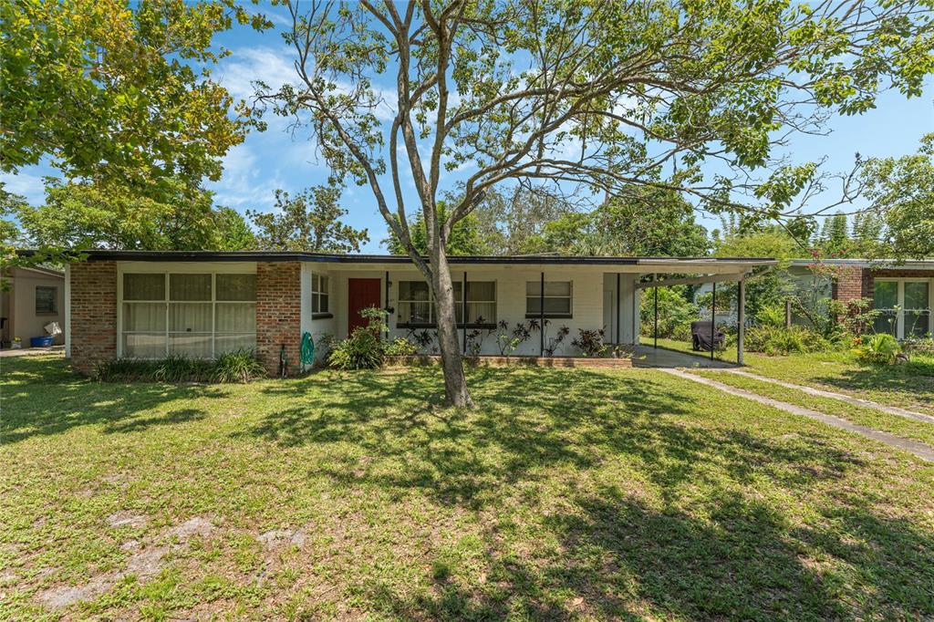 a backyard of a house with table and chairs