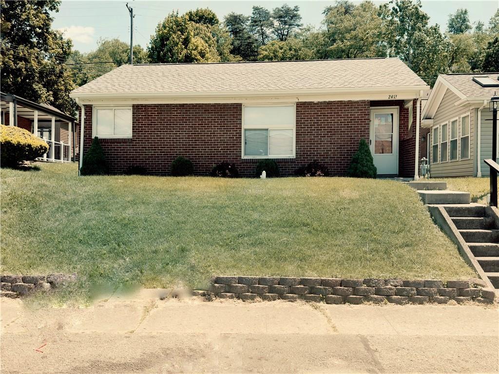 a front view of a house with a yard