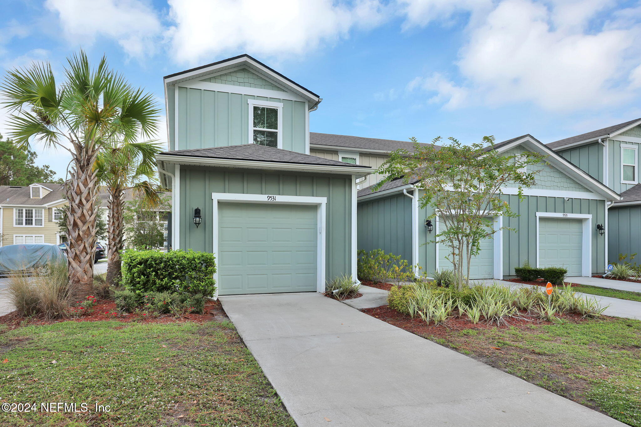 a front view of a house with a yard and garage