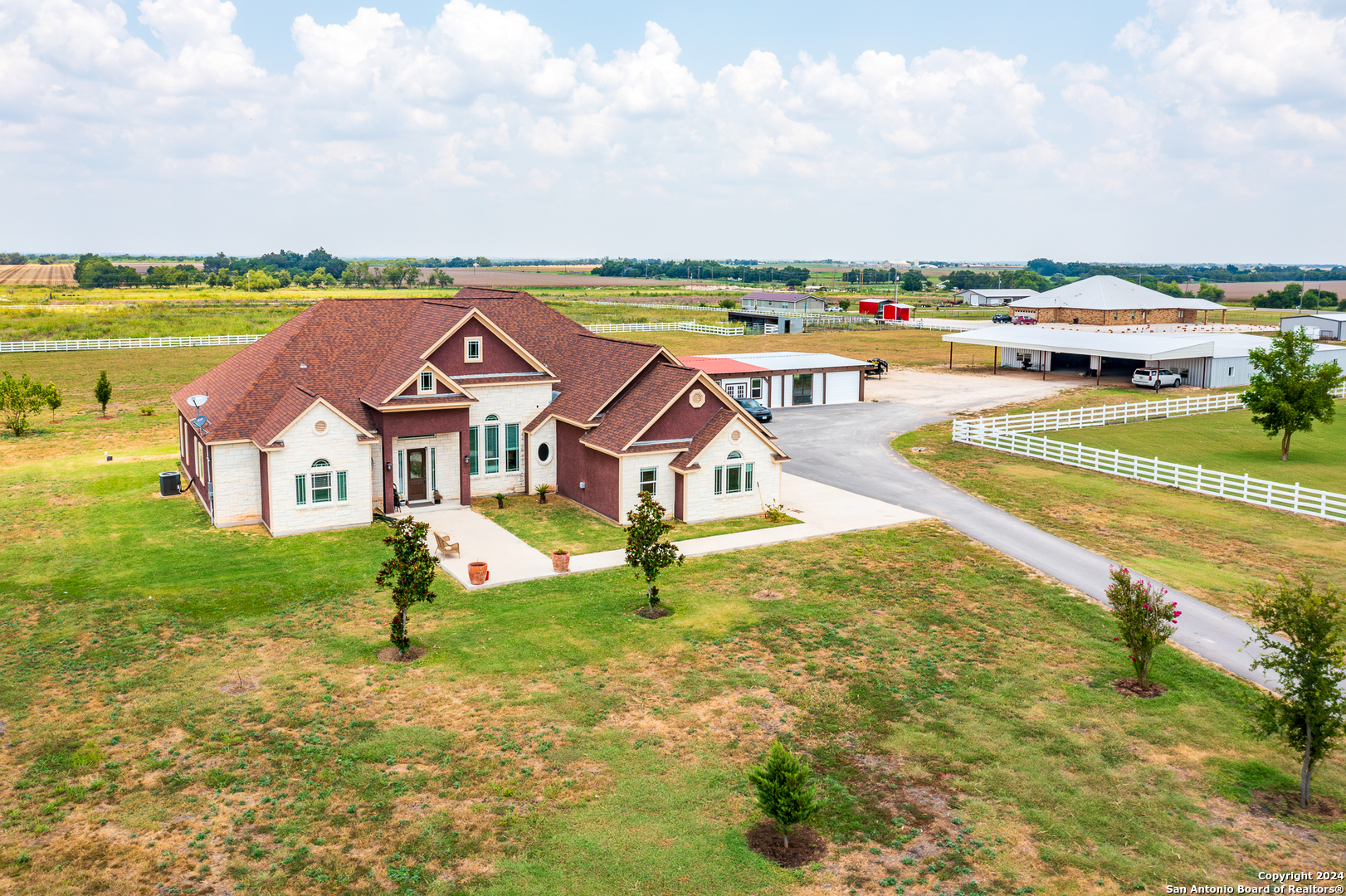 an aerial view of residential houses with outdoor space and swimming pool