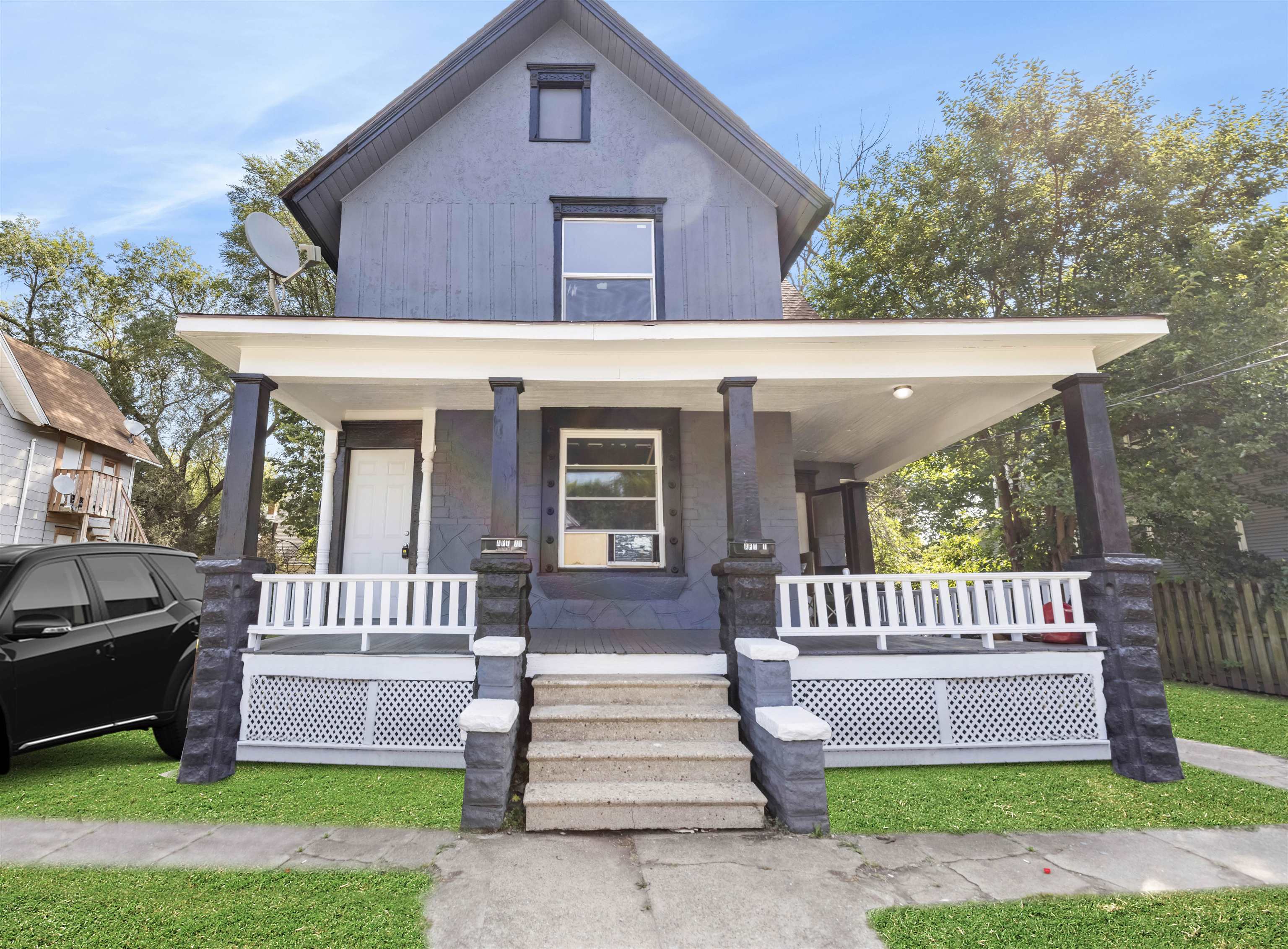 a front view of a house with a yard table and chairs