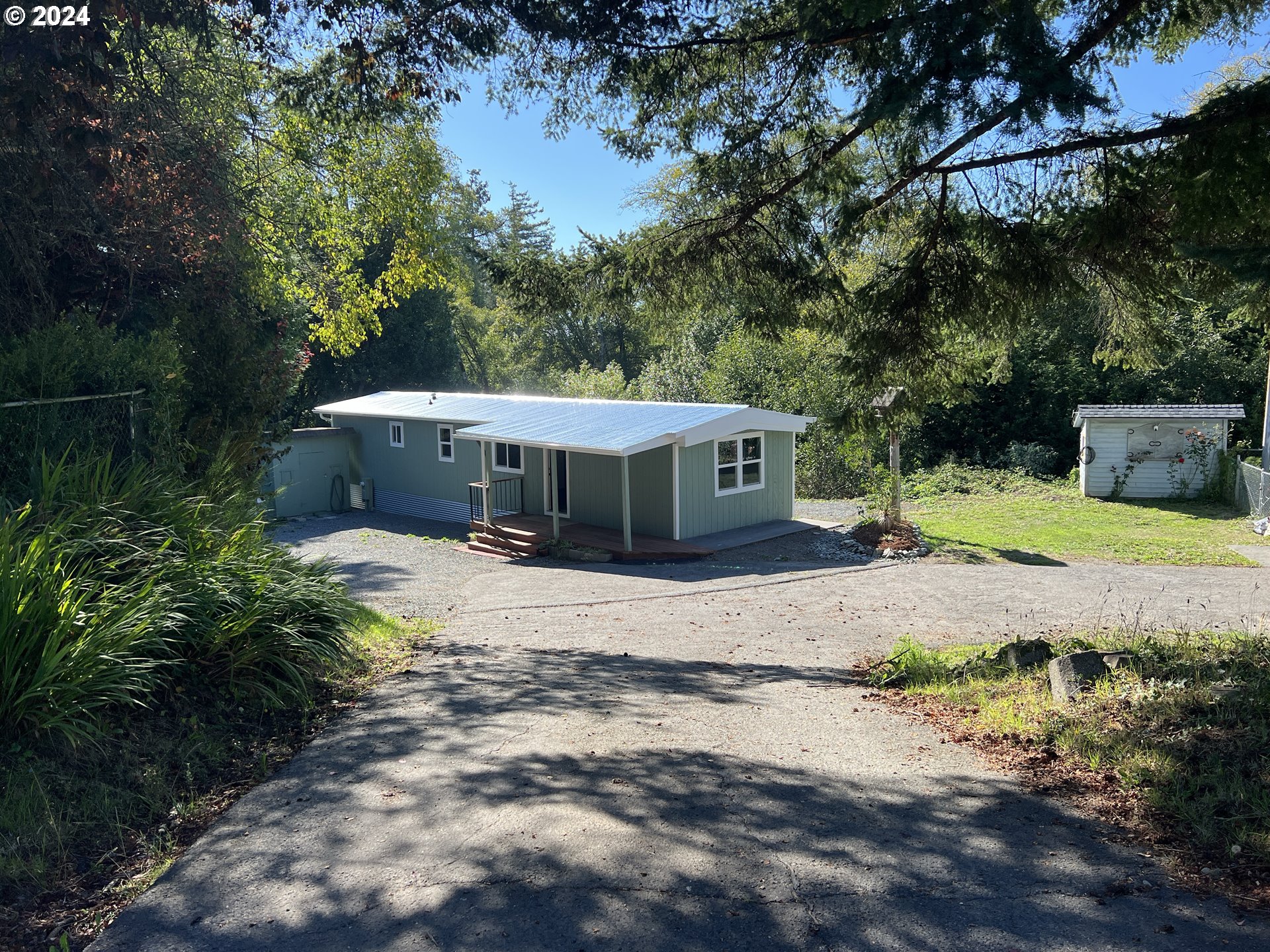 a view of a house with yard and sitting area