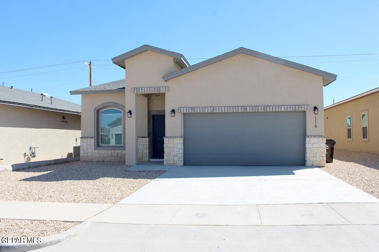 a front view of a house with a garage