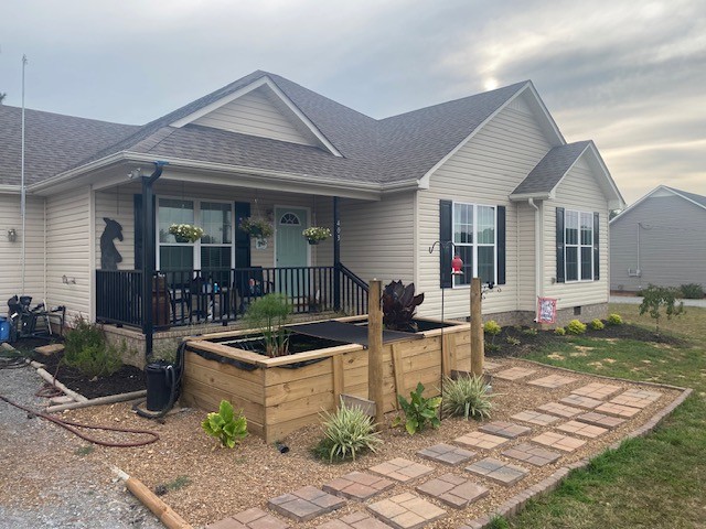 a front view of house with yard outdoor seating and barbeque oven