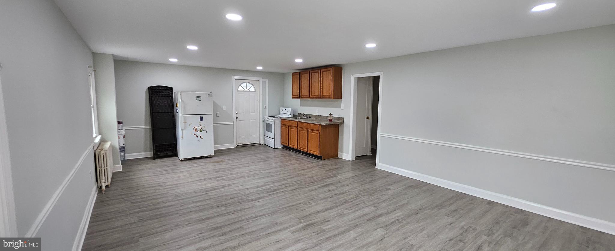 a view of a kitchen with a sink and a refrigerator