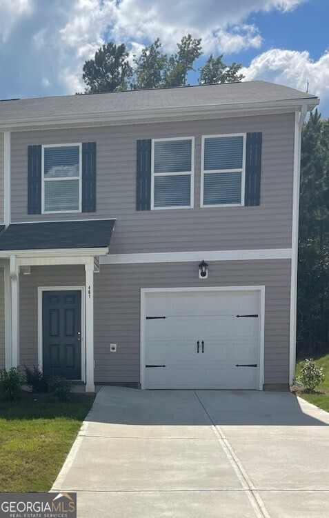 a front view of a house with garage