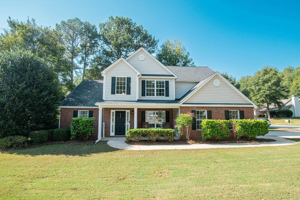 a front view of a house with a yard