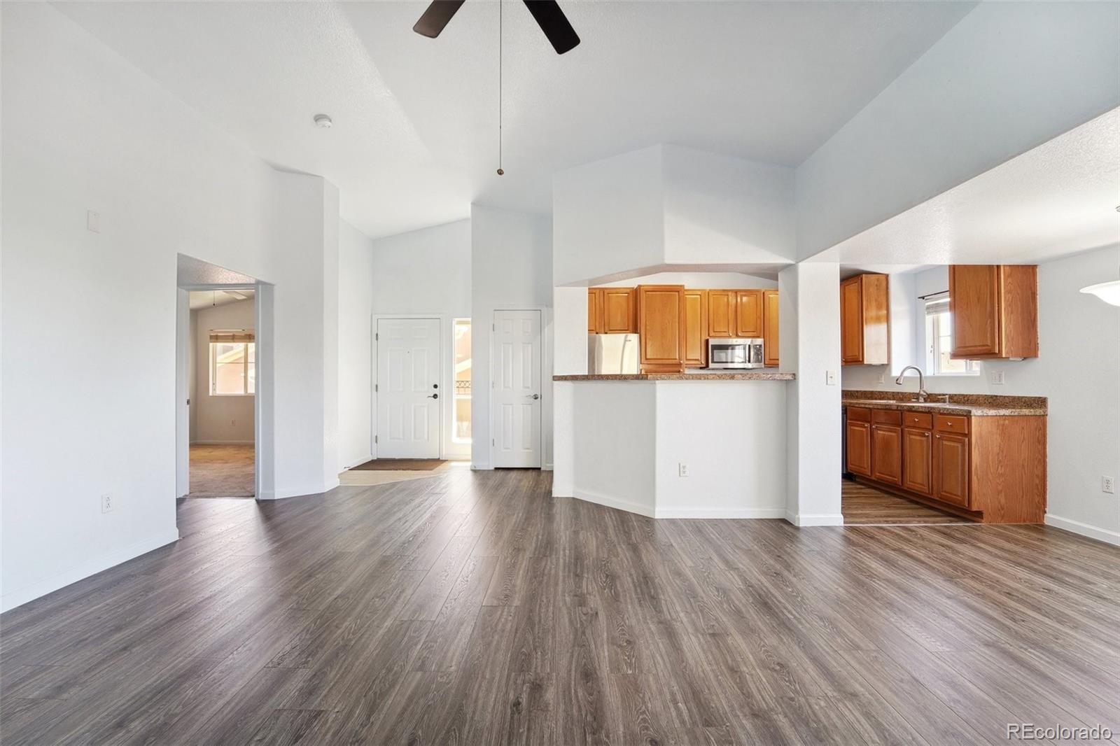 a view of a kitchen with wooden floor