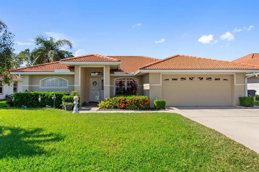 a front view of a house with a garden and yard