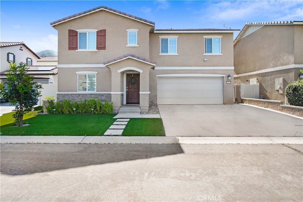 a front view of a house with a yard and garage