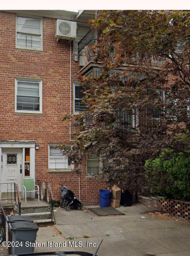 a brick building with a bench in front of it