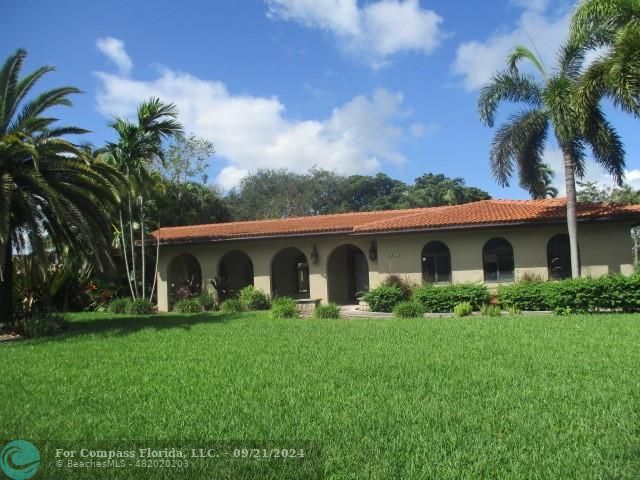 a front view of house with yard and green space